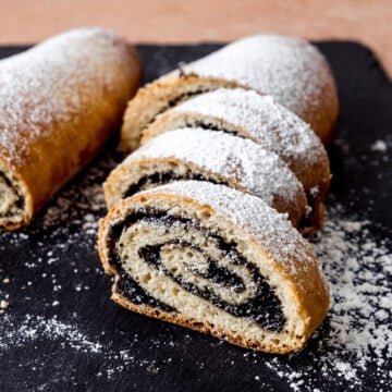 Polish poppyseed roll called makowiec, dusted with powdered sugar on top.