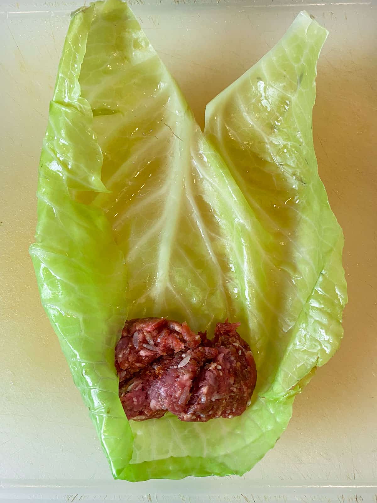 Add 2 tablespoons of the beef mixture to the cabbage leaf.