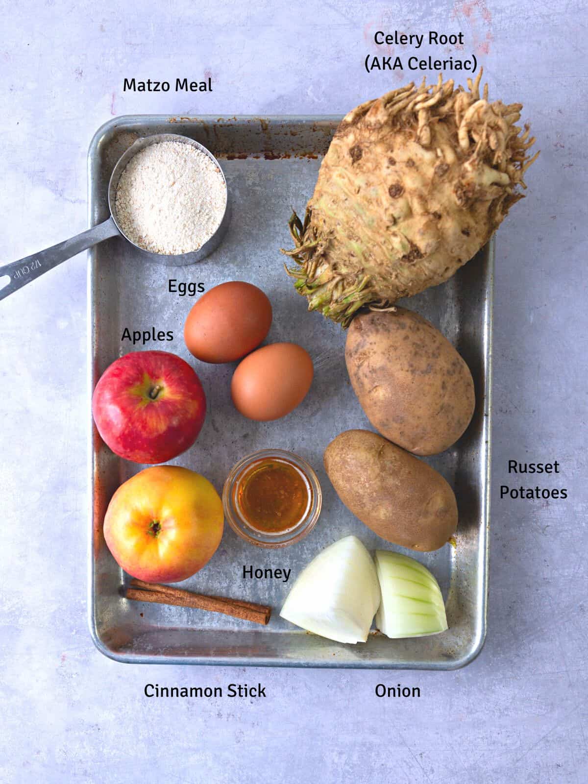 Ingredients for celery root latkes, including potatoes, eggs, matzo meal and ingredients for homemade applesauce.