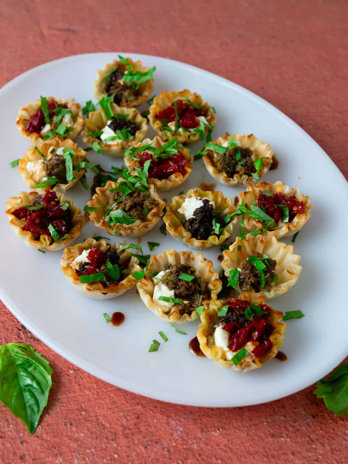 Savory phyllo appetizer with goat cheese, pesto, sun-dried tomatoes and olive tapenade.
