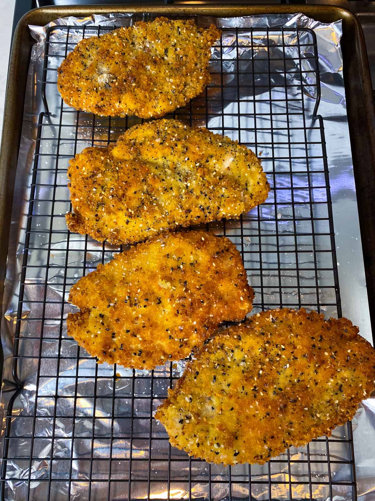 Drain the fried chicken cutlets on a wire rack.