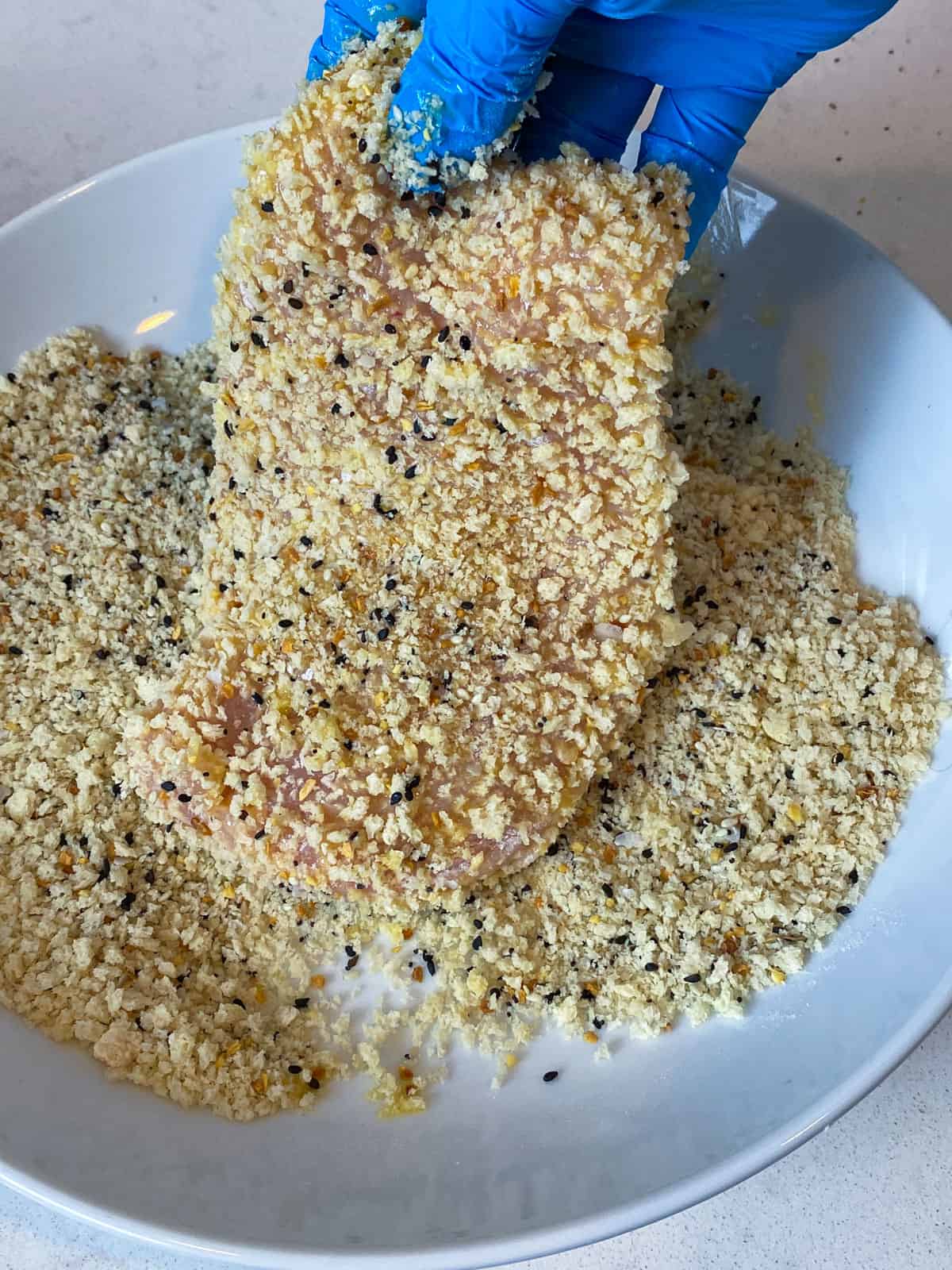 Press the chicken cutlets into panko breadcrumbs on both sides.