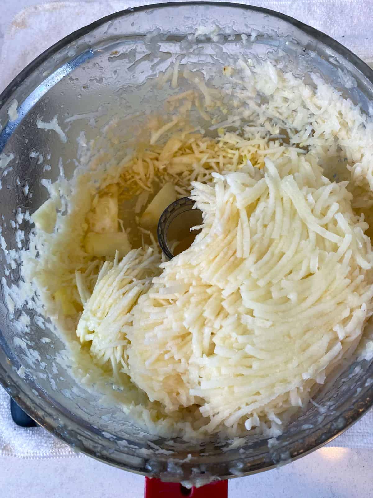 Shred the celery root and potatoes in a food processor or use a hand grater.