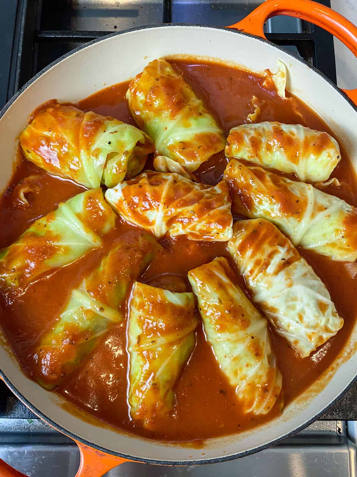 Pour the sweet and sour tomato sauce over the rolled cabbage rolls.