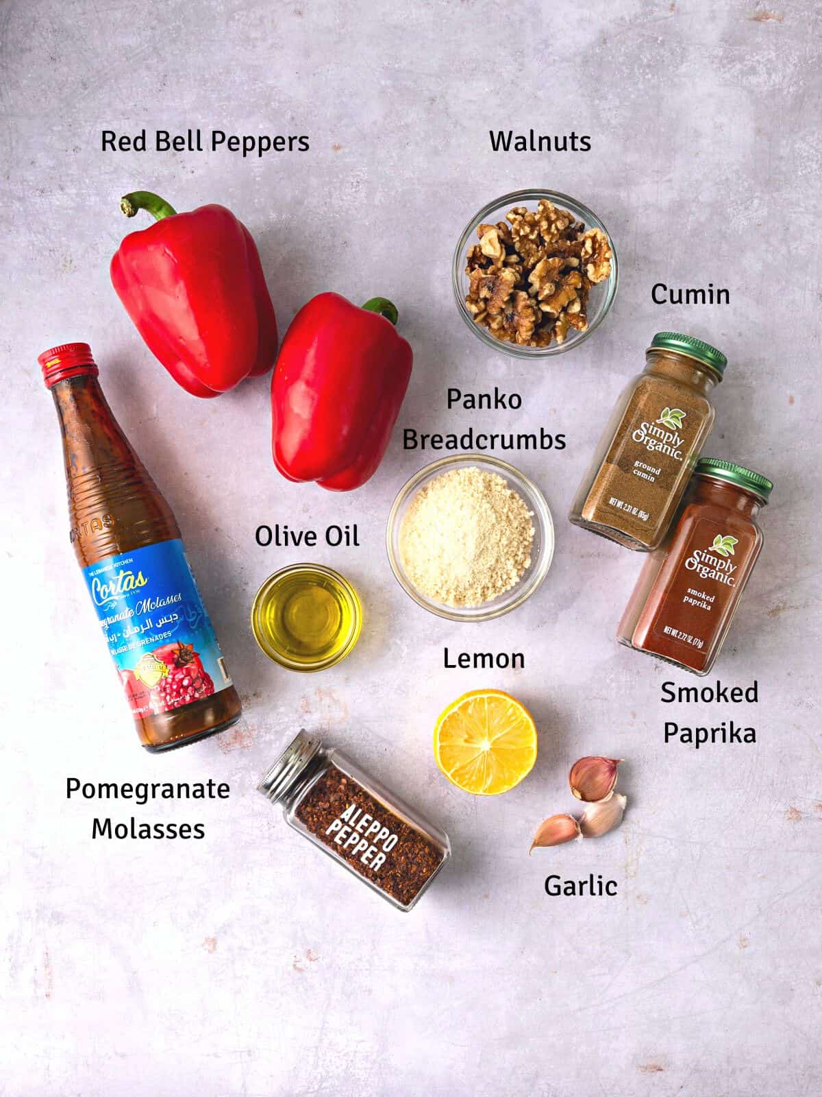 Ingredients for Turkish red pepper dip called muhammara with pomegranate molasses, cumin, paprika and garlic.