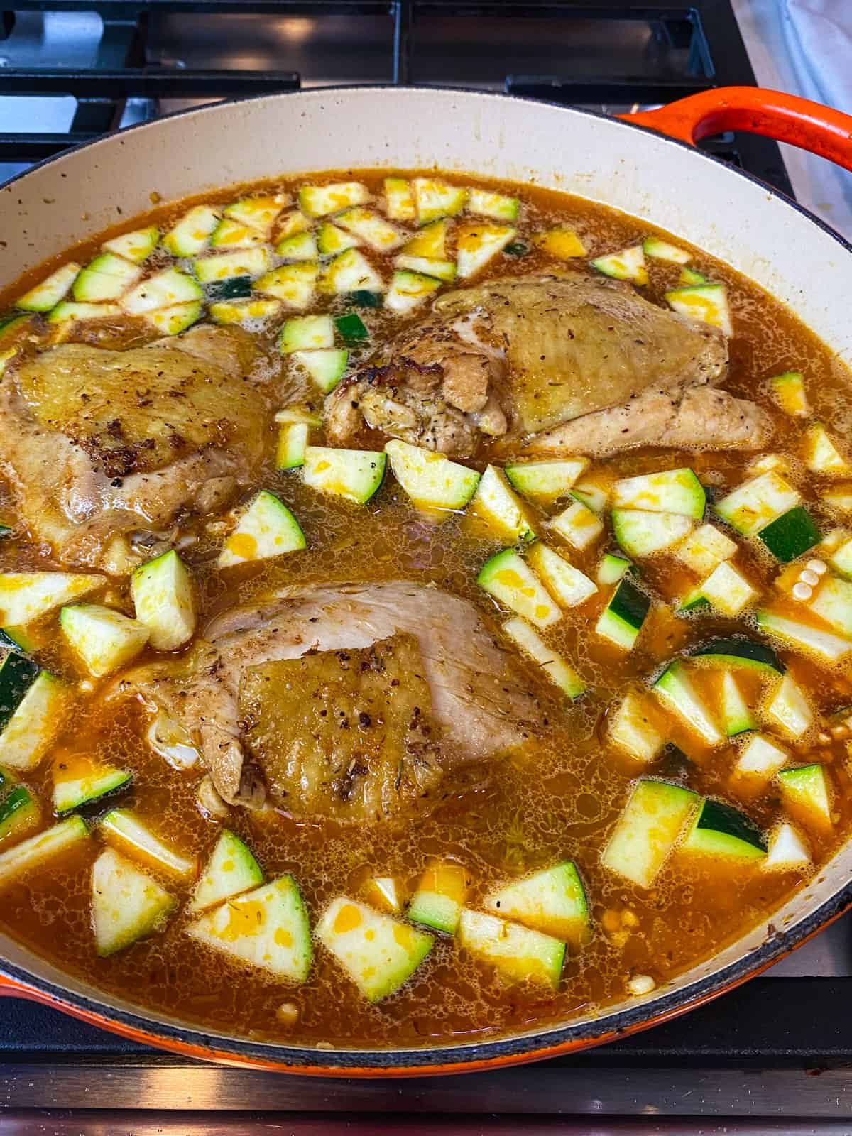 Add the seared chicken back into the broth with the pearl couscous and zucchini.