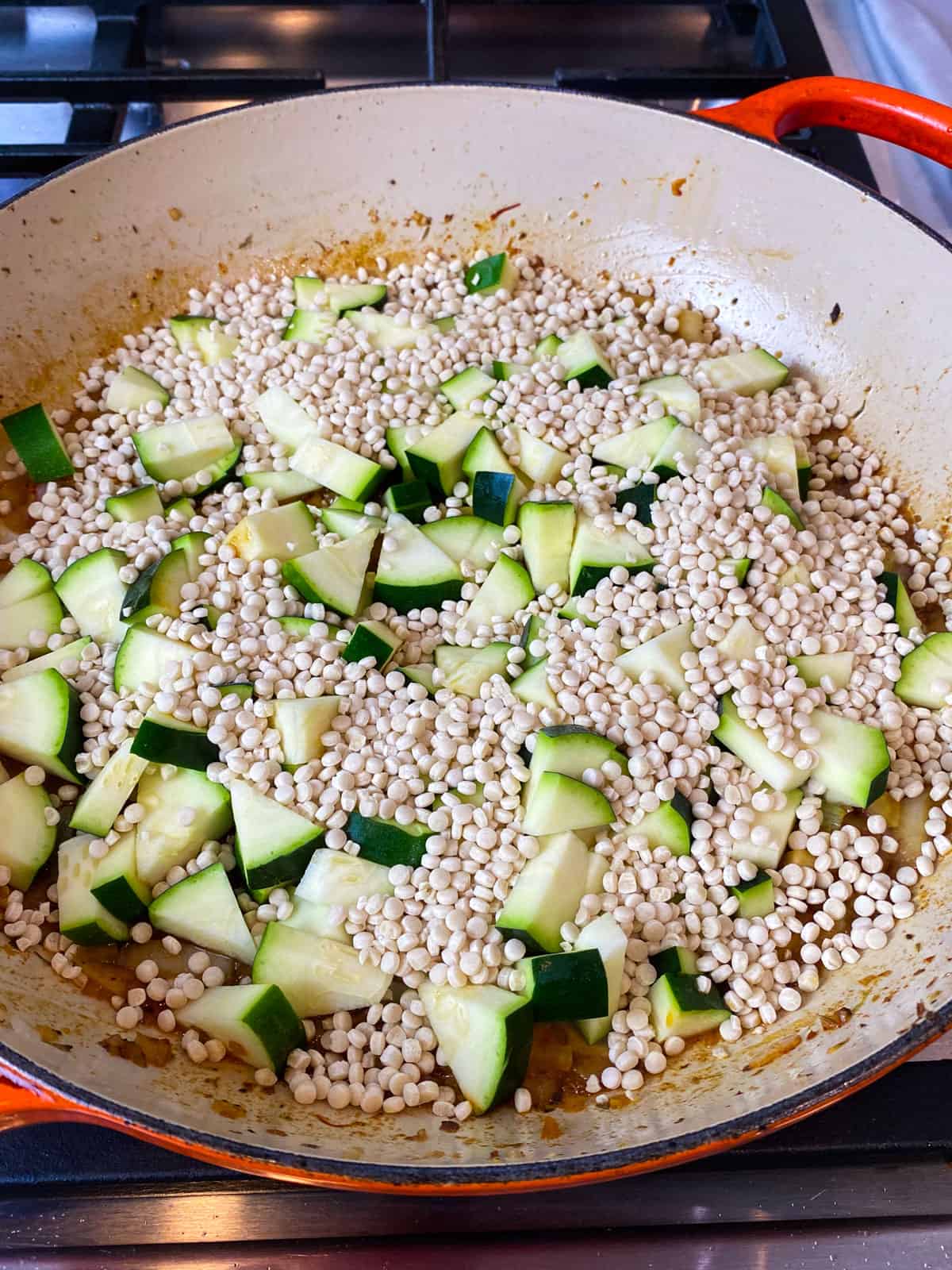 Add the Israeli couscous and chopped zucchini.