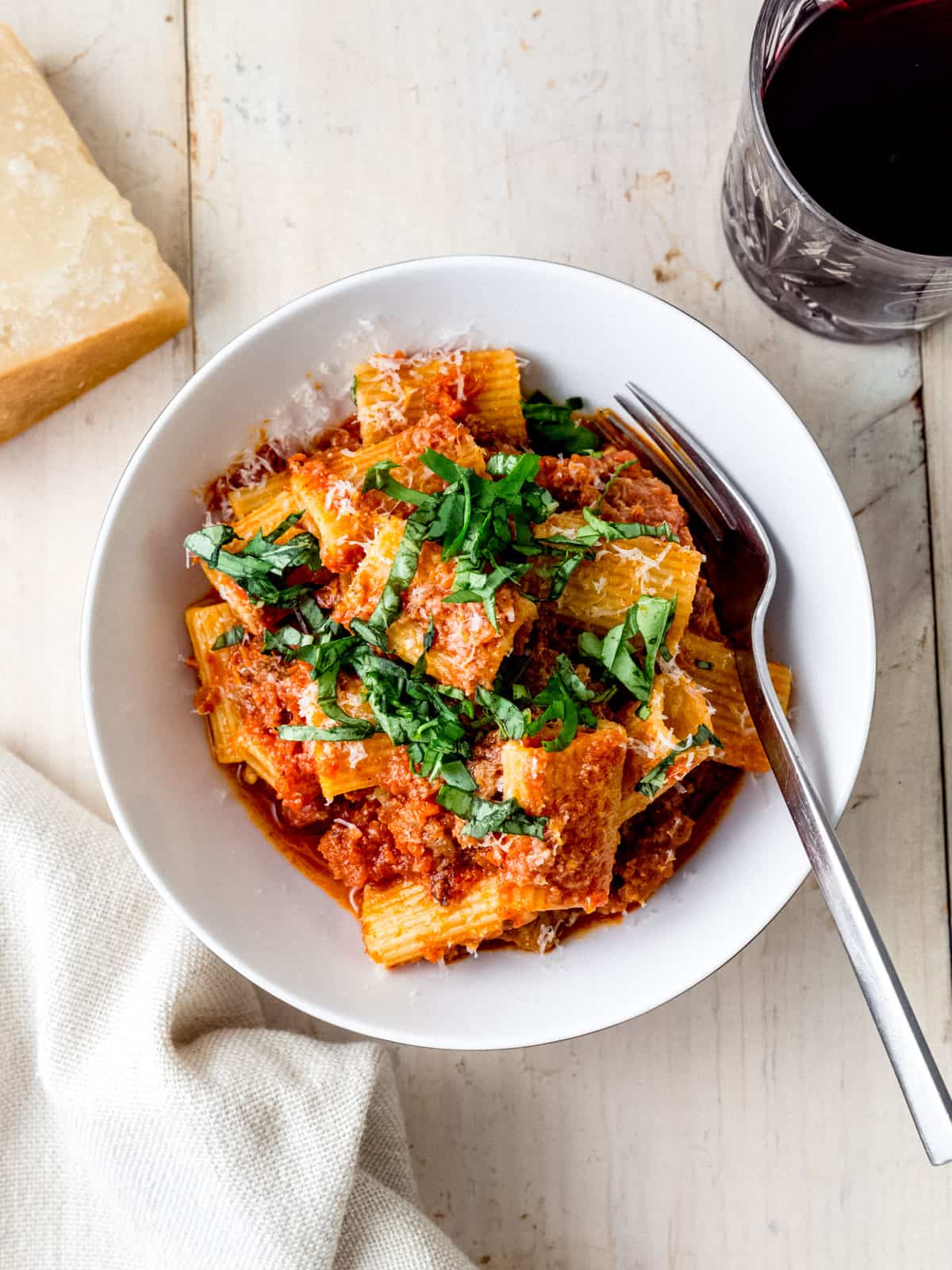 Spicy pork ragu with rigatoni and topped with grated Parmesan and fresh herbs.