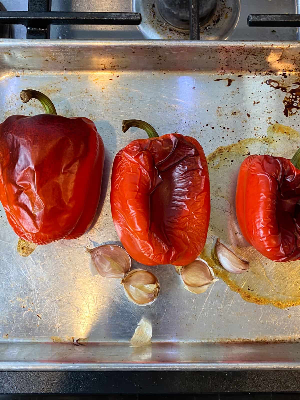 Roast the red peppers and garlic until the outside os charred and peppers are tender.