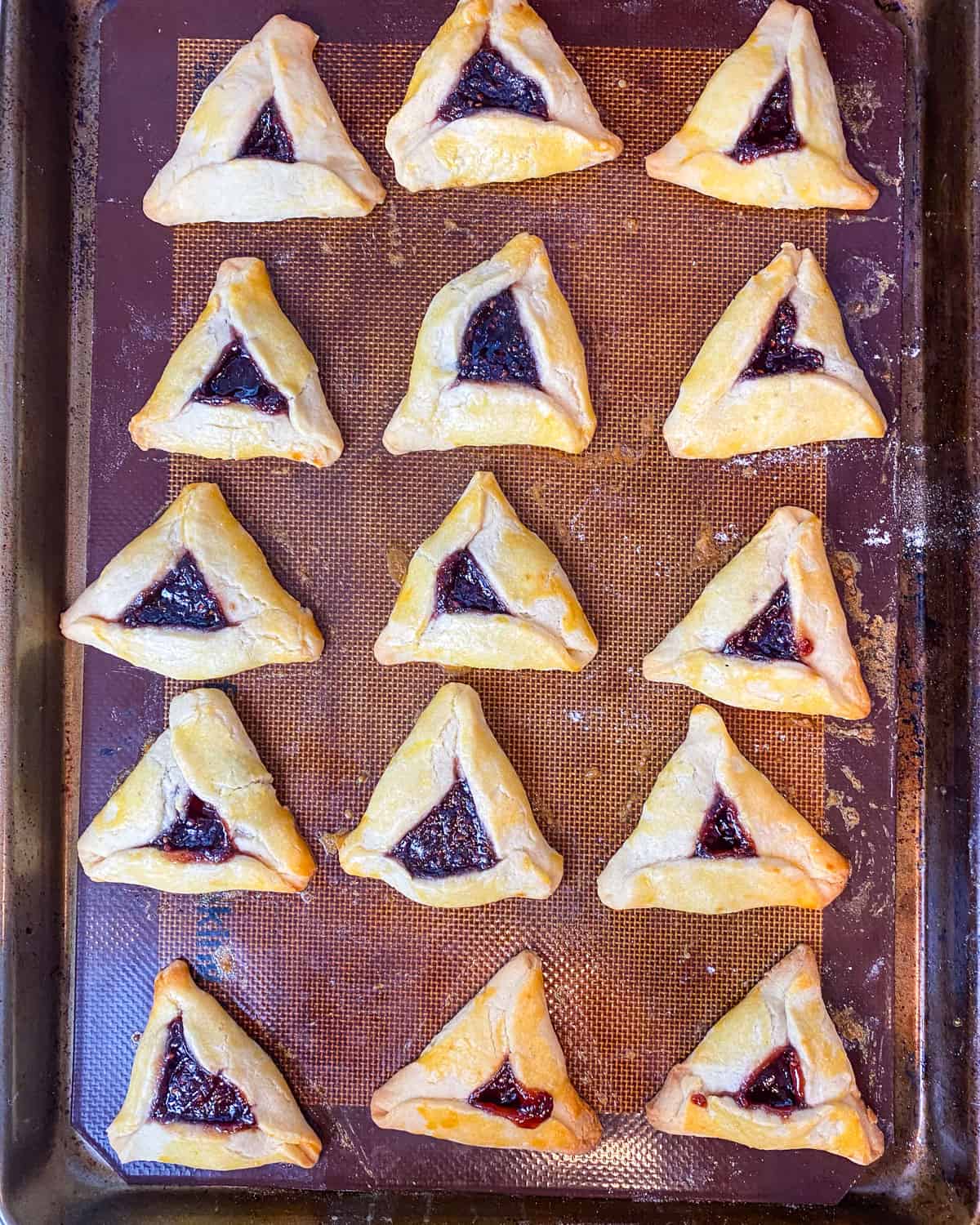 Bake the hamantaschen cookies at 350 degrees Fahrenheit until lightly golden brown, for about 22-25 minutes.