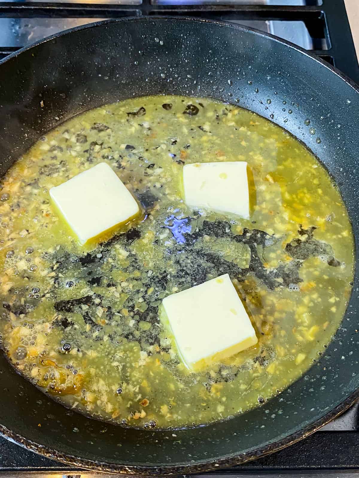 Add butter to the piccata sauce.