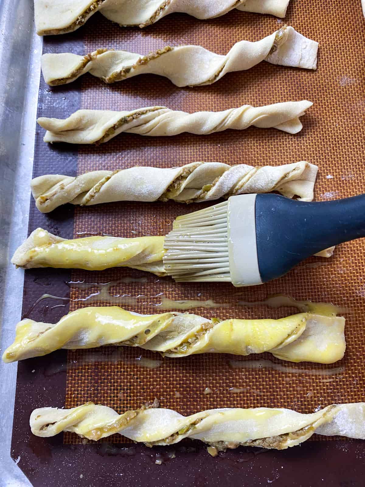 Brush egg wash onto each puff pastry twist.