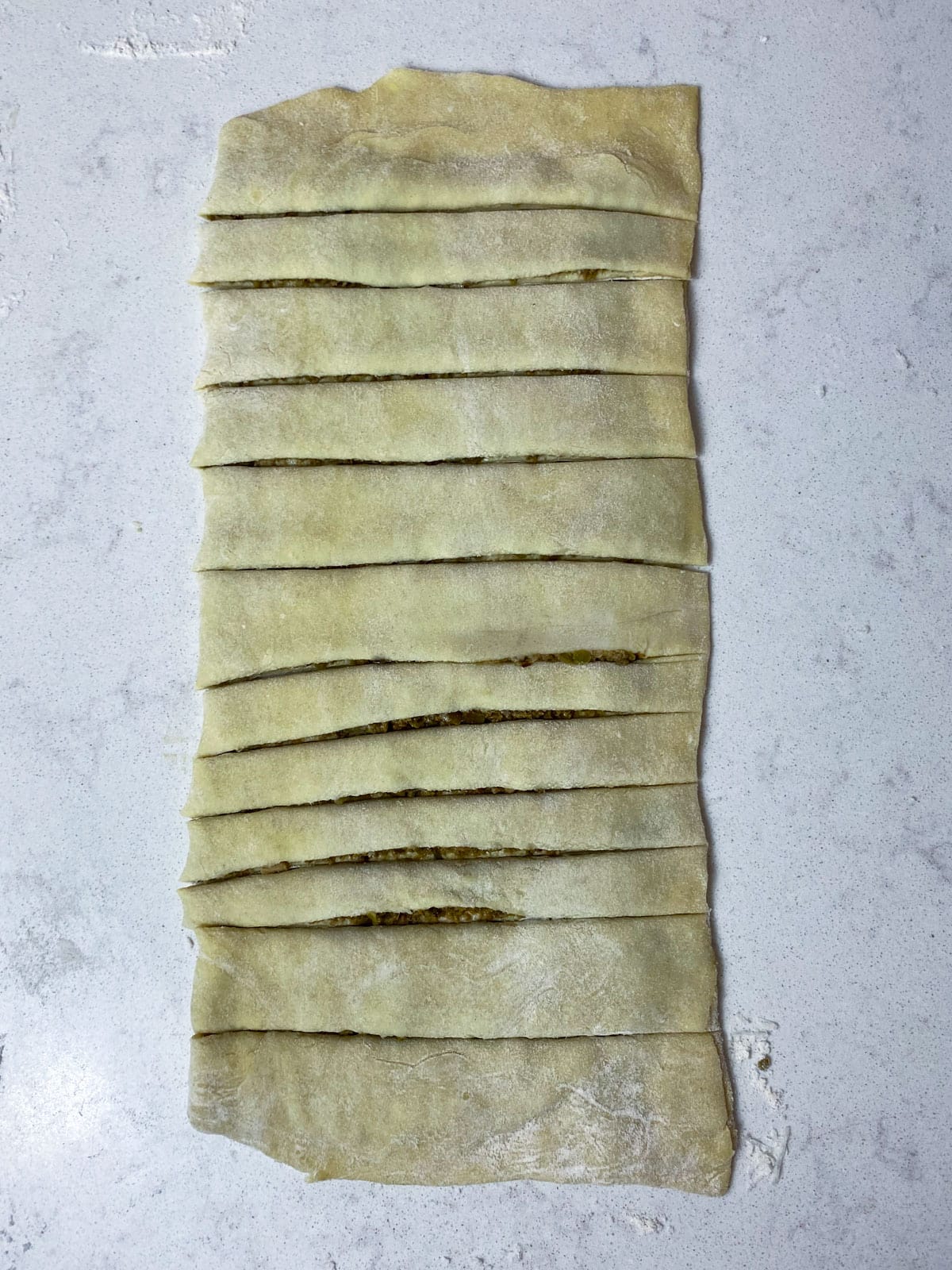 Cut long strips into the puff pastry.