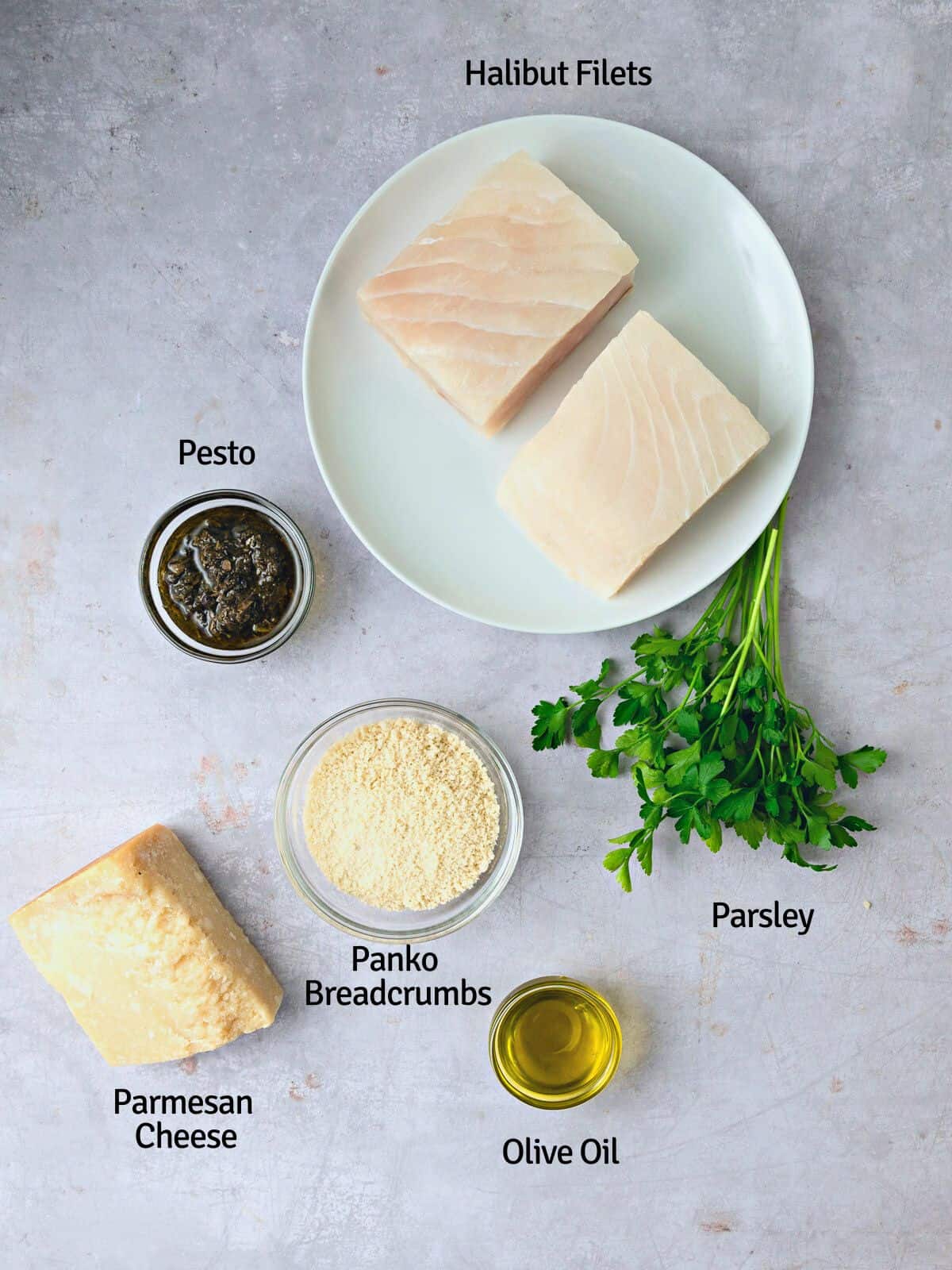 Ingredients for panko crusted halibut, including pesto, Parmesan cheese, olive oil and fresh parsley.