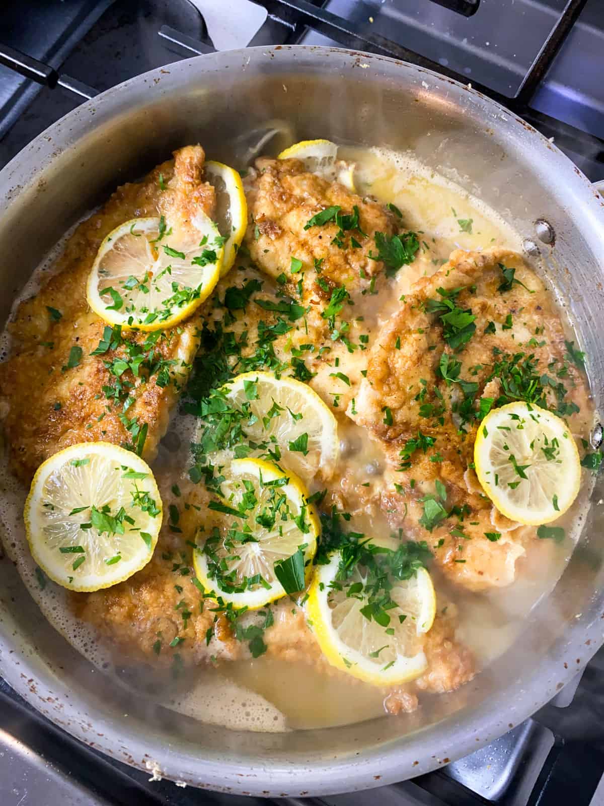 Add lemon slices and chopped parsley to the chicken francese.
