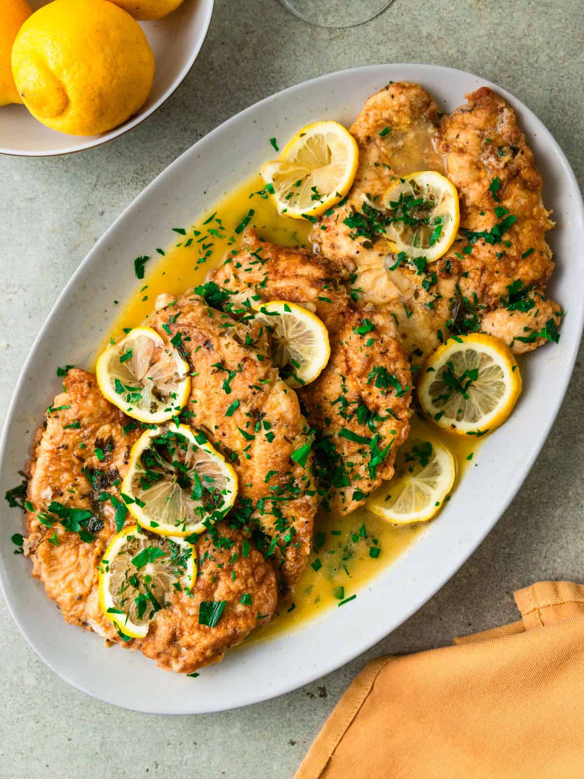 Lemony chicken francaise recipe with tender chicken cutlets coated in a buttery white wine sauce.