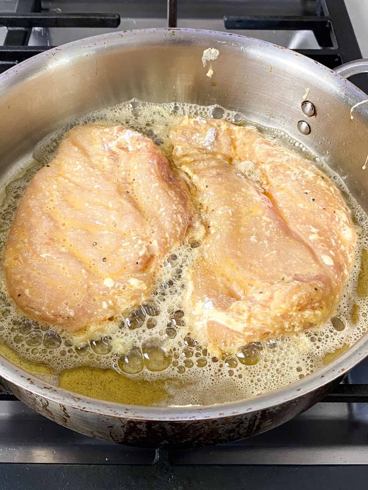 Cook the chicken cutlets on th first side until golden brown.