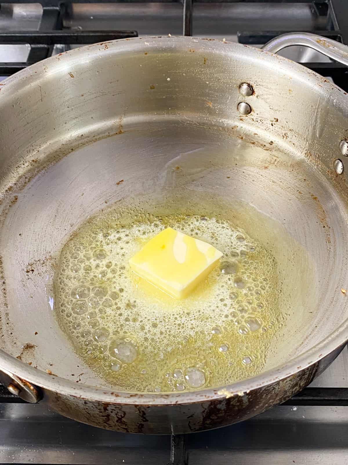 Once the chicken cutlets are cooked and removed, add more butter to the skillet.