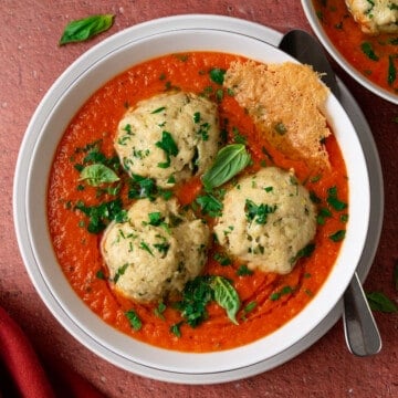 Roasted tomato soup with cheesy matzo balls and basil.