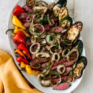 Tender grilled flank steak with a flavorful marinade alongside grilled vegetables.