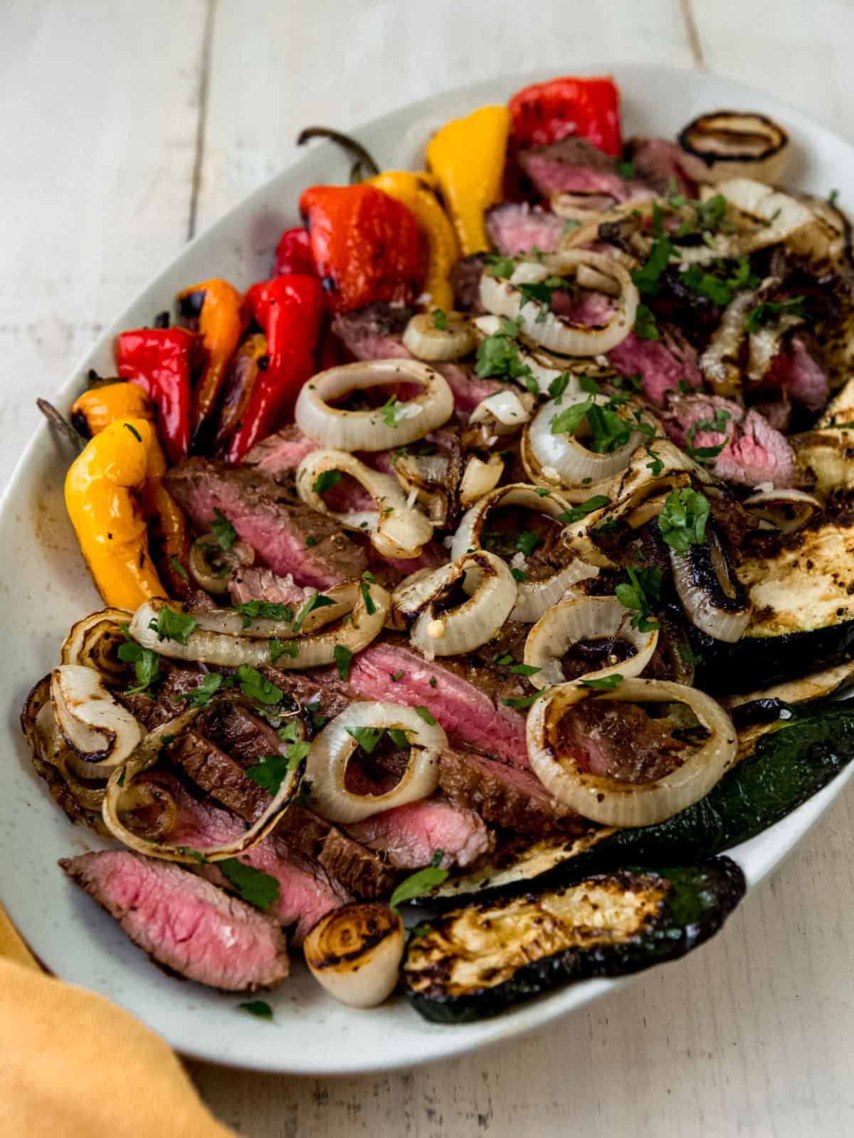 Grilled flank steak with grilled zucchini, peppers and onions.