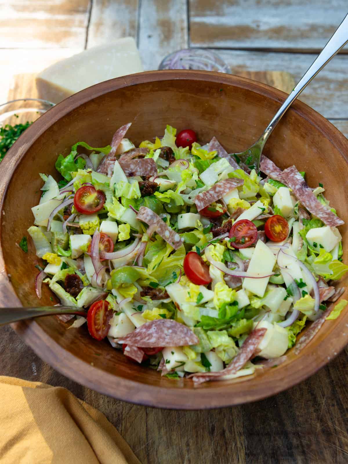 Chopped antipasto salad with salami and olives.