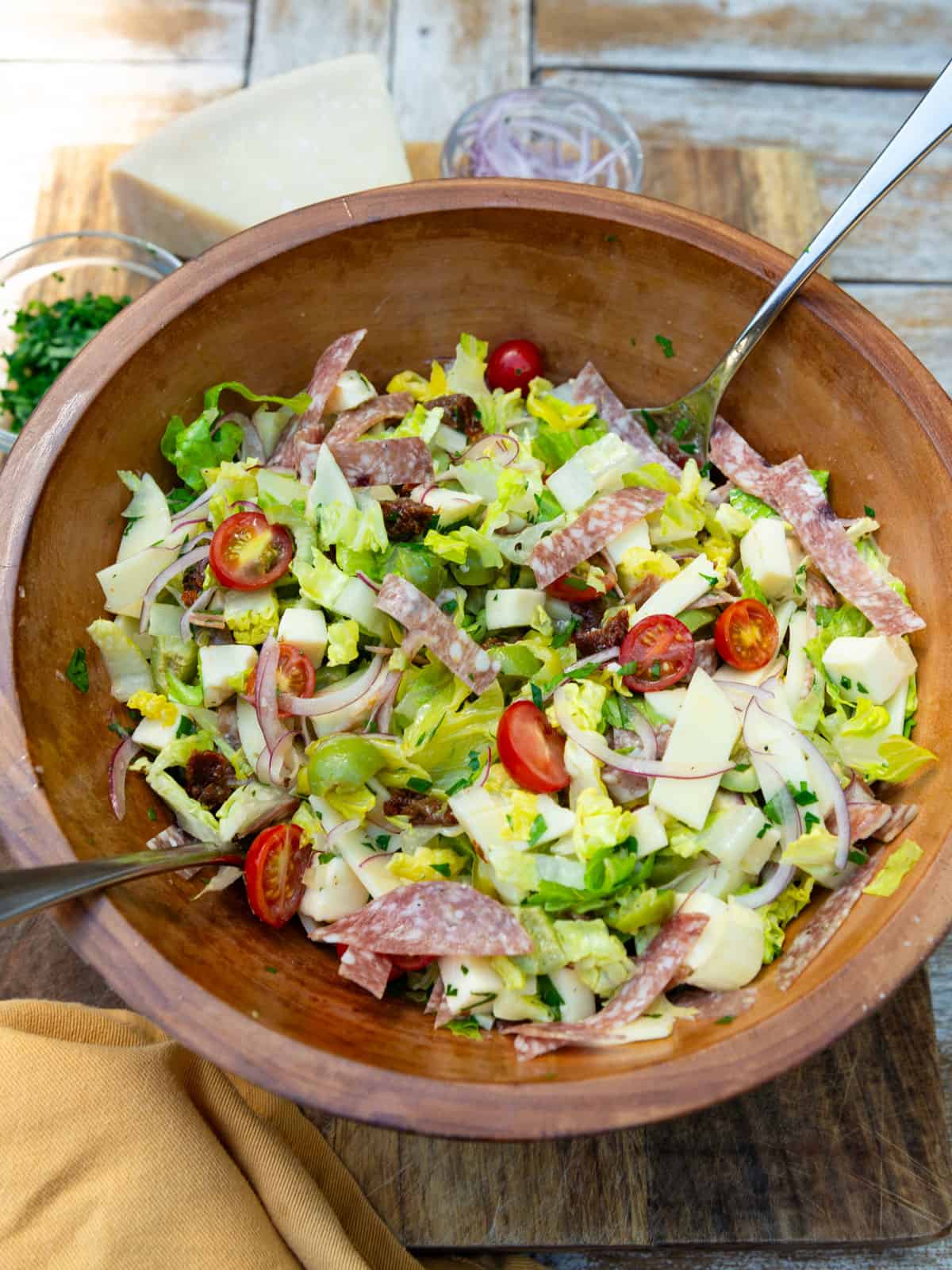 Chopped antipasto salad recipe with romaine, provolone cheese, salami and olives.