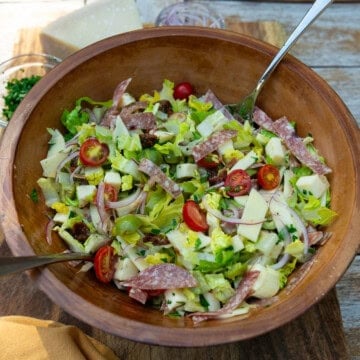 Chopped antipasto salad with cherry tomatoes, salami, olives and mozzarella.