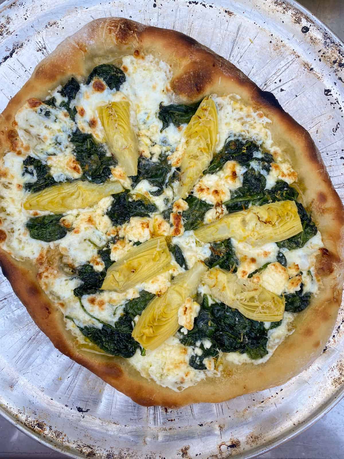 Cook the spinach pizza until crisp os crisp and golden brown.