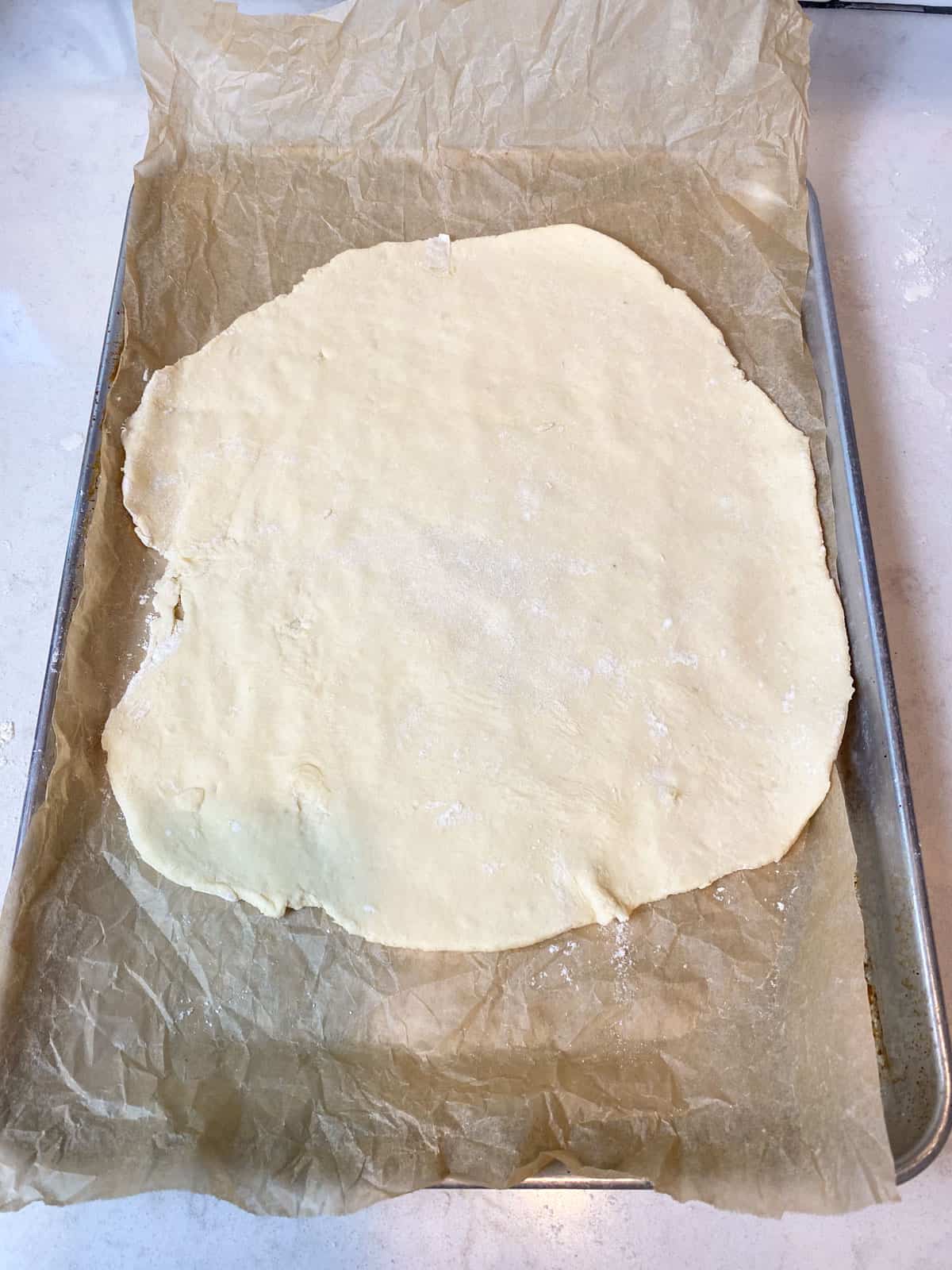 Transfer the dough to a lined baking sheet before layering.