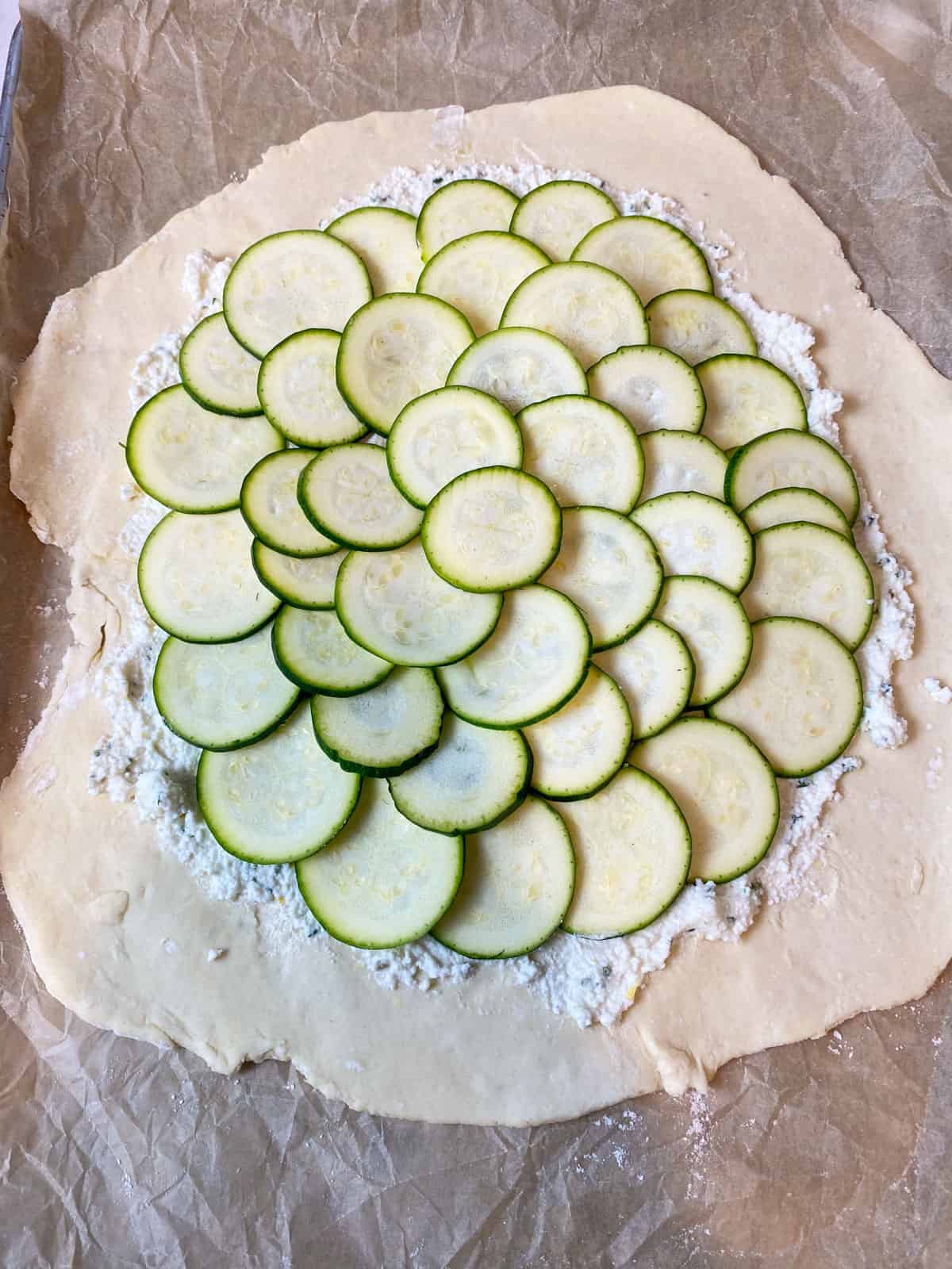 Layer the zucchini slices on top of the ricotta mixture.