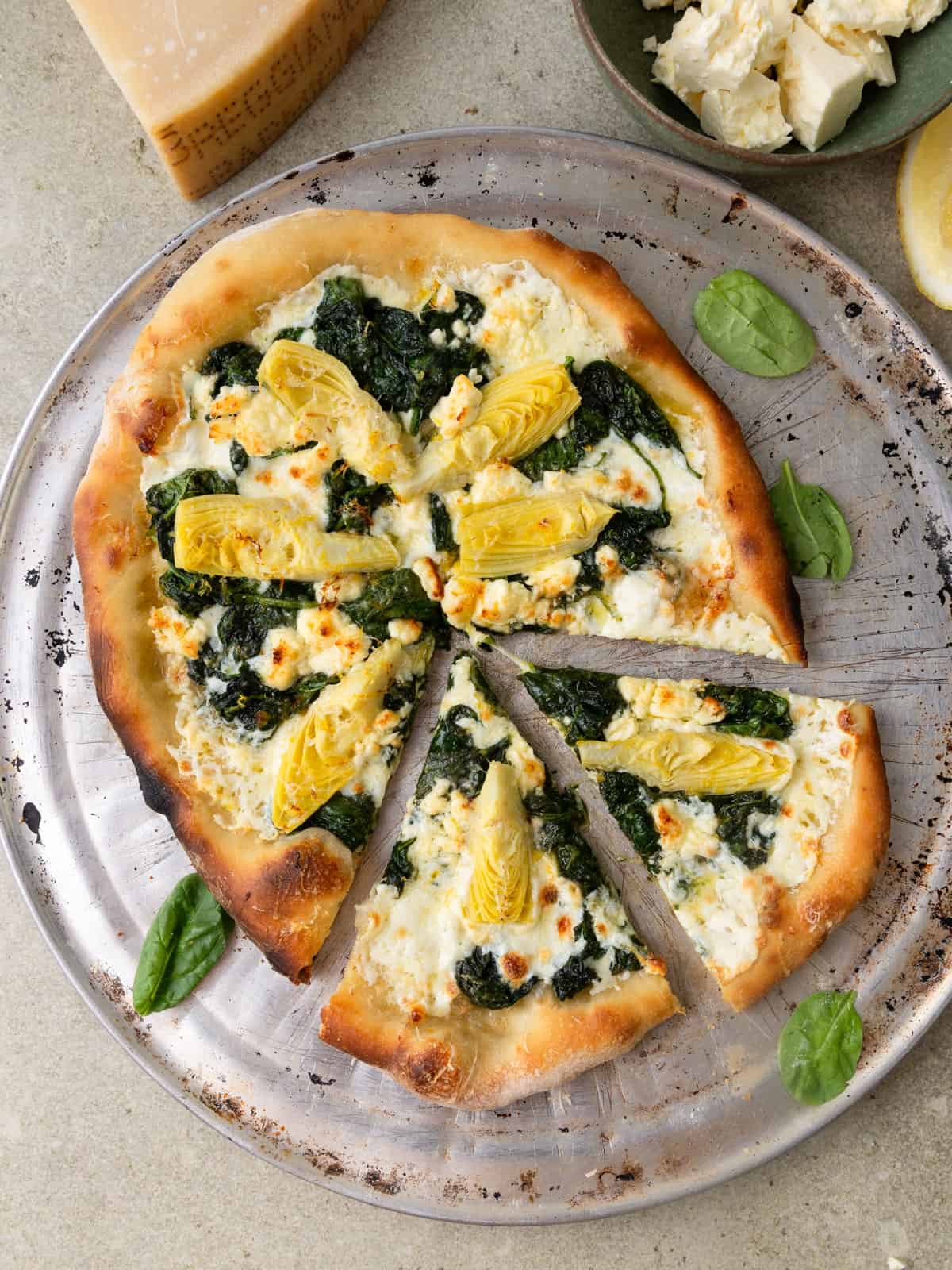 Spinach and artichoke pizza with spinach and mozzarella cheese.