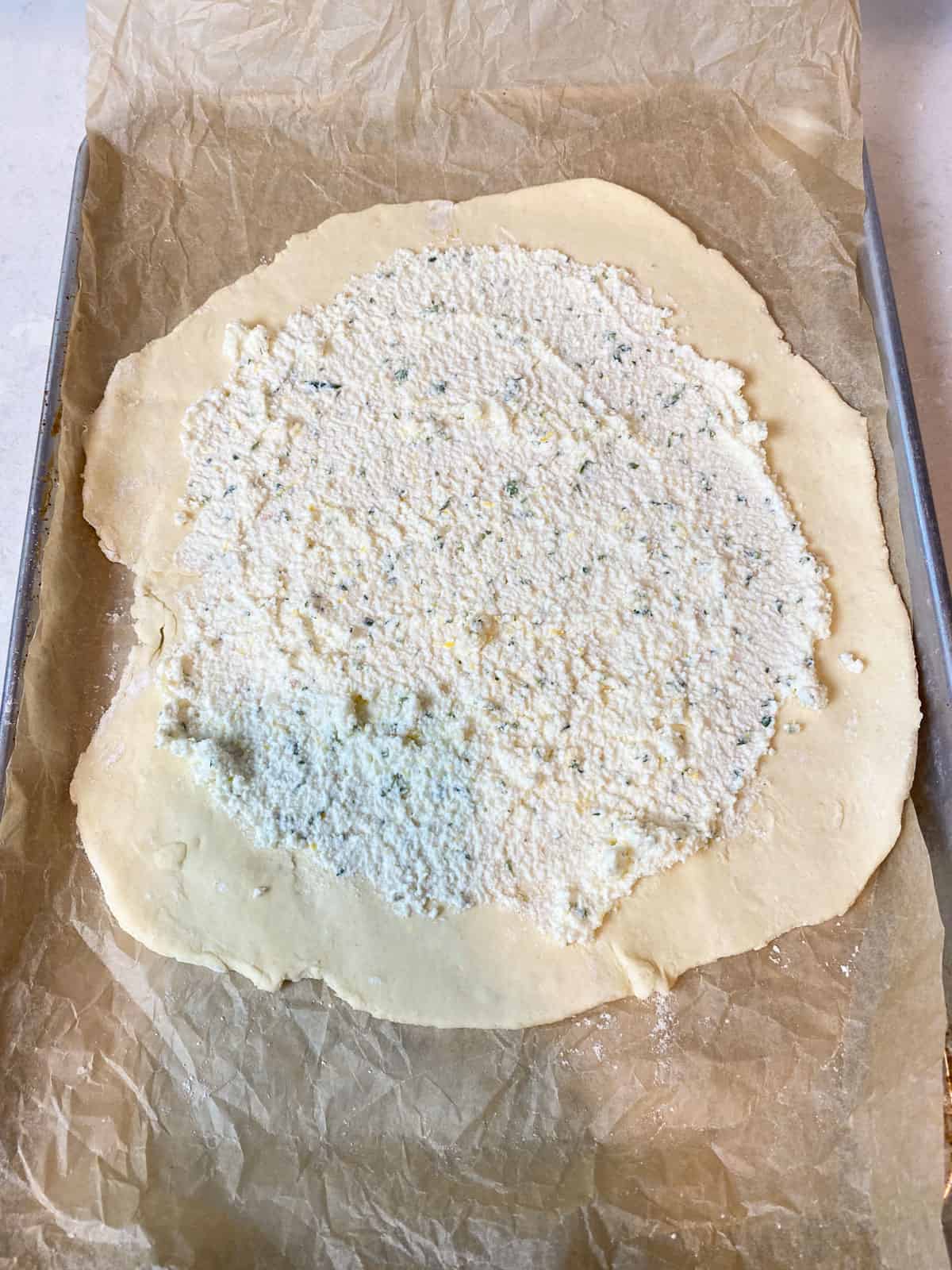 Spread the ricotta mixture into a thin layer onto the galette dough.