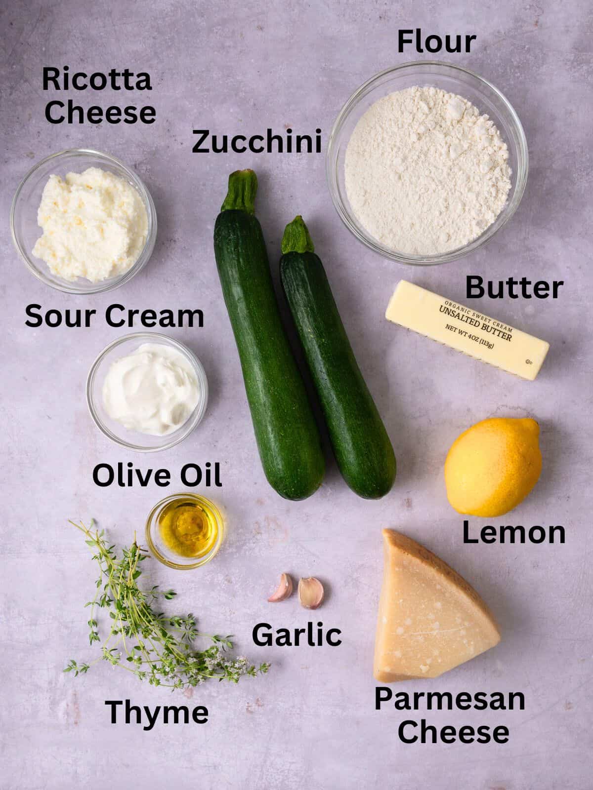 Ingredients for zucchini galette, including sour cream, Parmesan cheese and fresh thyme.