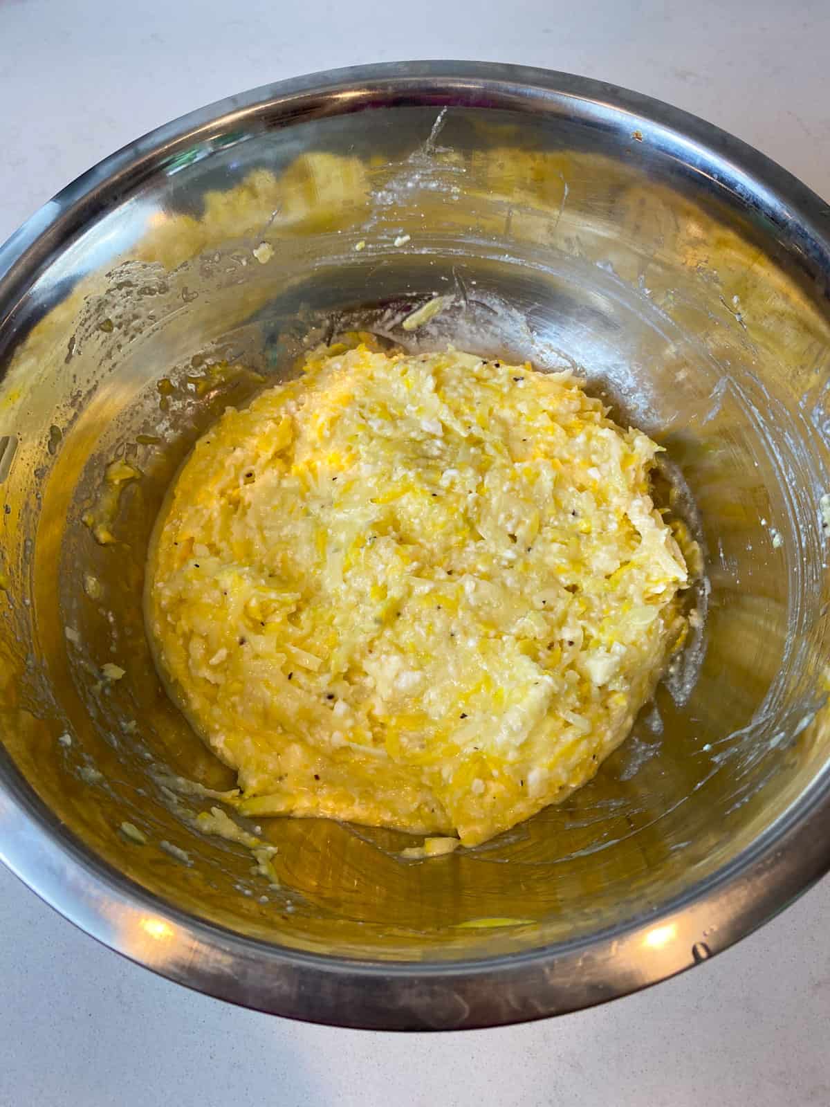 Add the shredded squash, cheeses, eggs and breadcrumbs to a bowl and mix well.