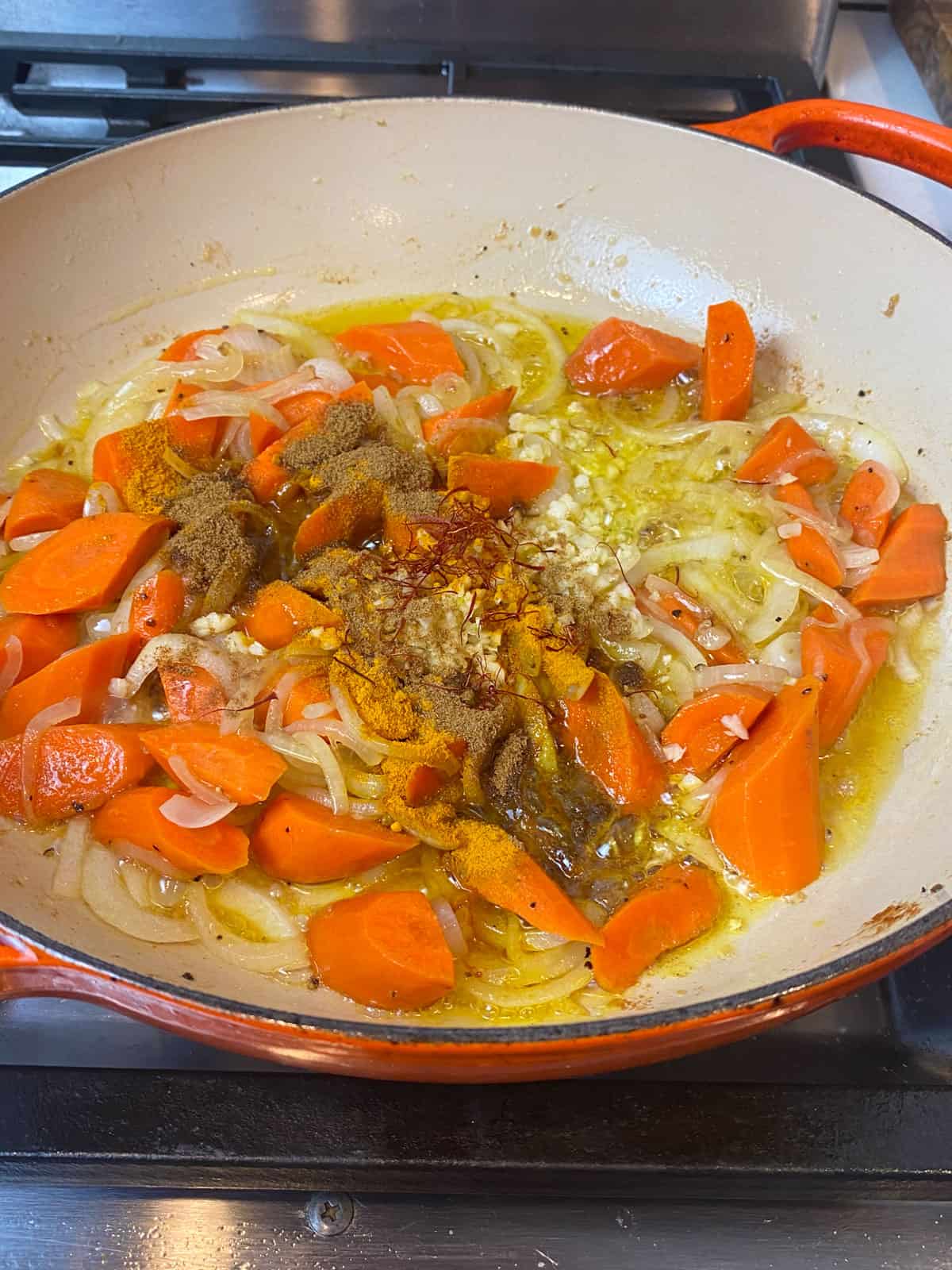 Add the turmeric, cumin and saffron to the sautéed onions and carrots.