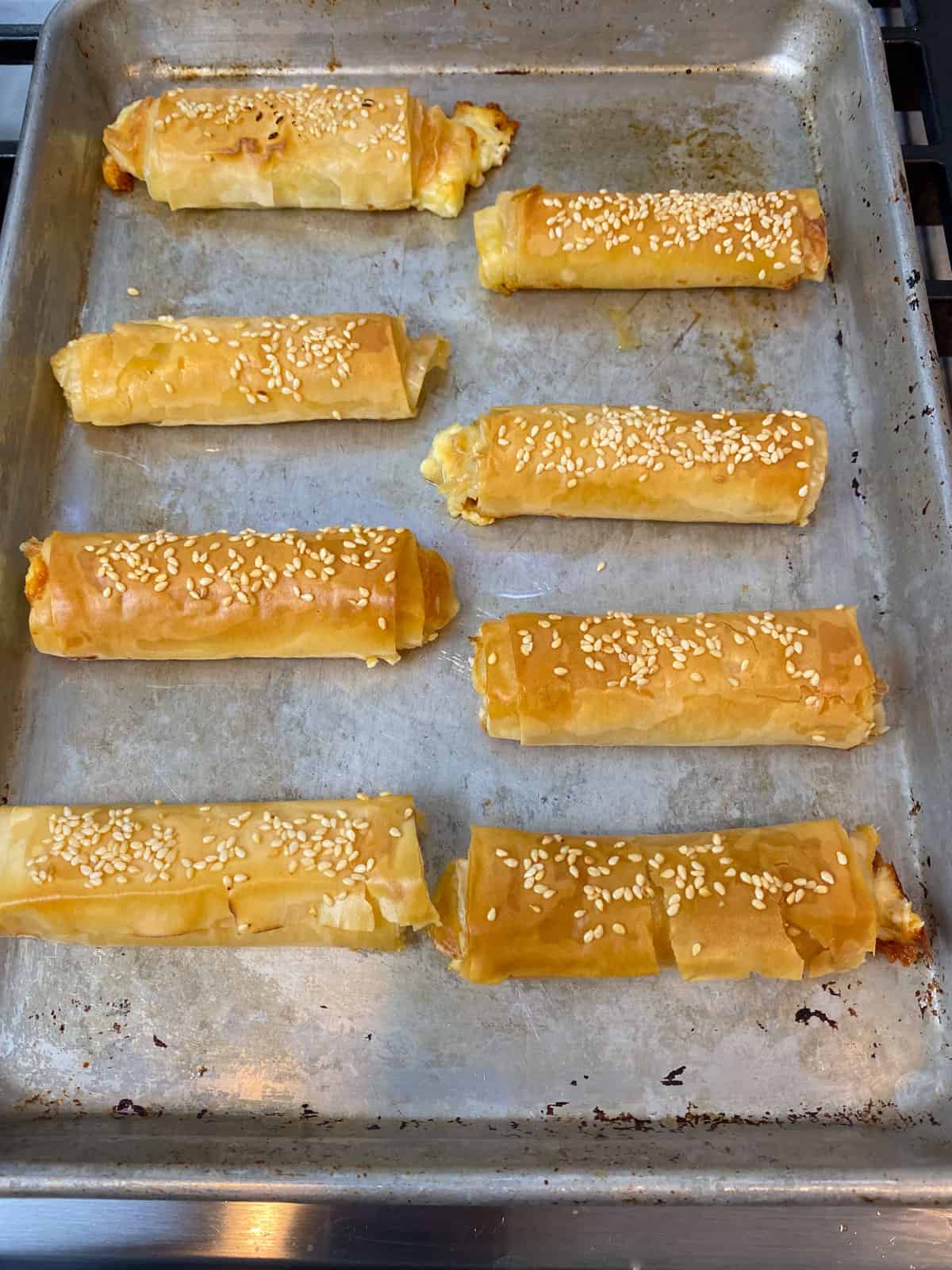 Bake the phyllo feta rolls until crisp and golden brown.