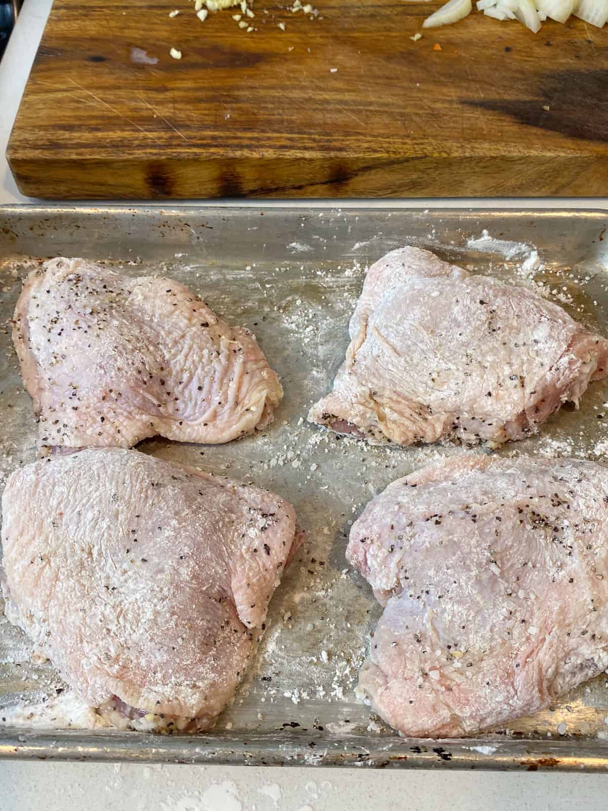 Dredge chicken thighs in cornstarch.