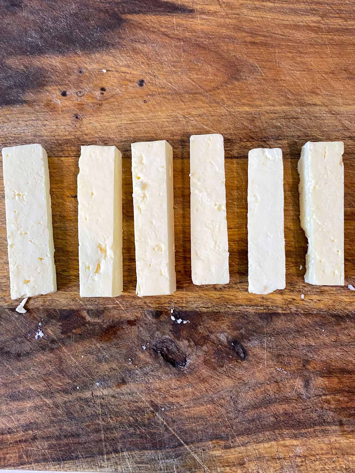 Cut the block of feta cheese into 1 inch thick rectangles that are about 2 inches long.