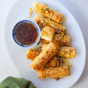 Feta phyllo rolls with sesame seeds and honey to dip into.