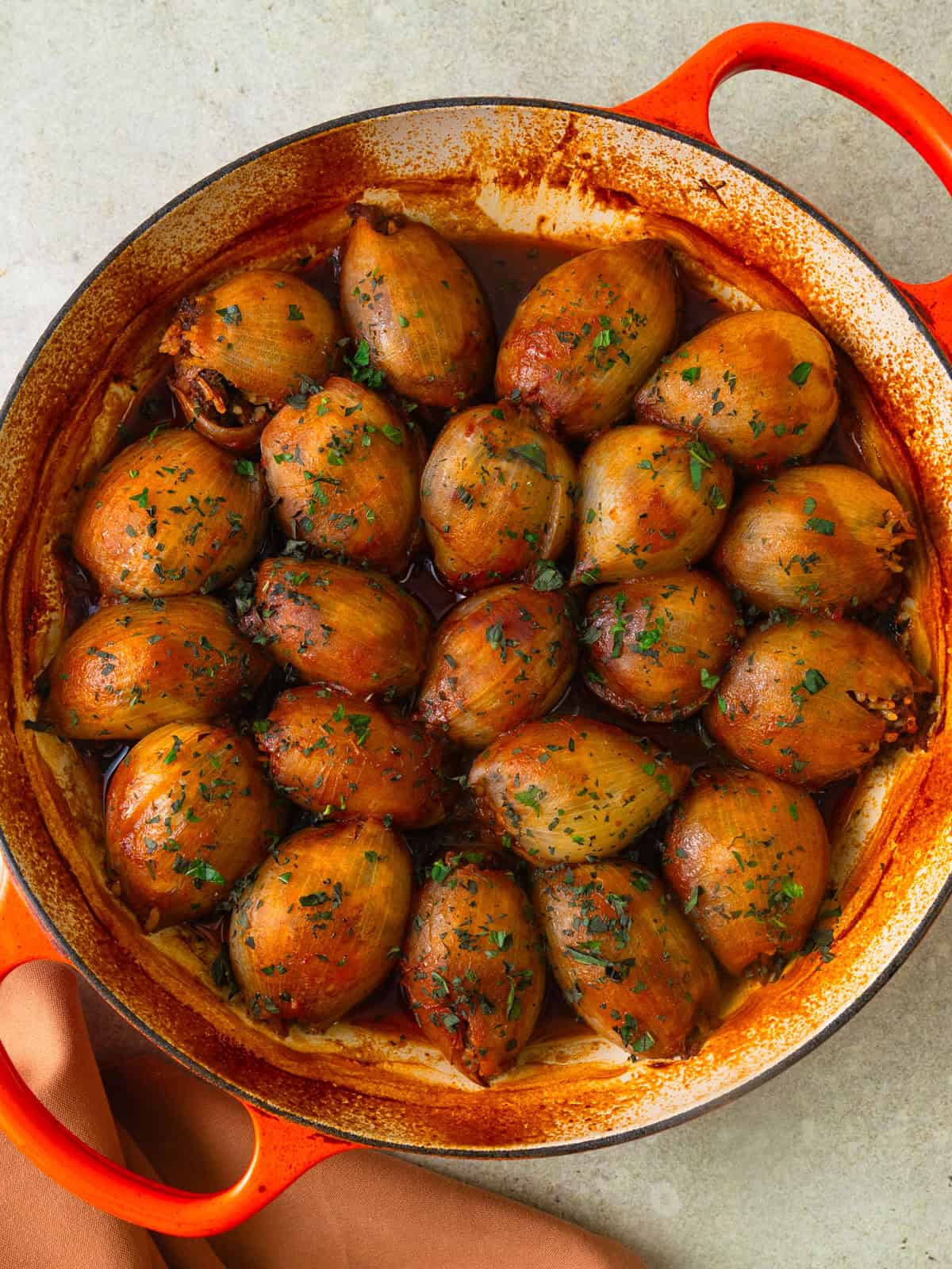 Middle Eastern stuffed onions with meat and rice in a rich tomato sauce.