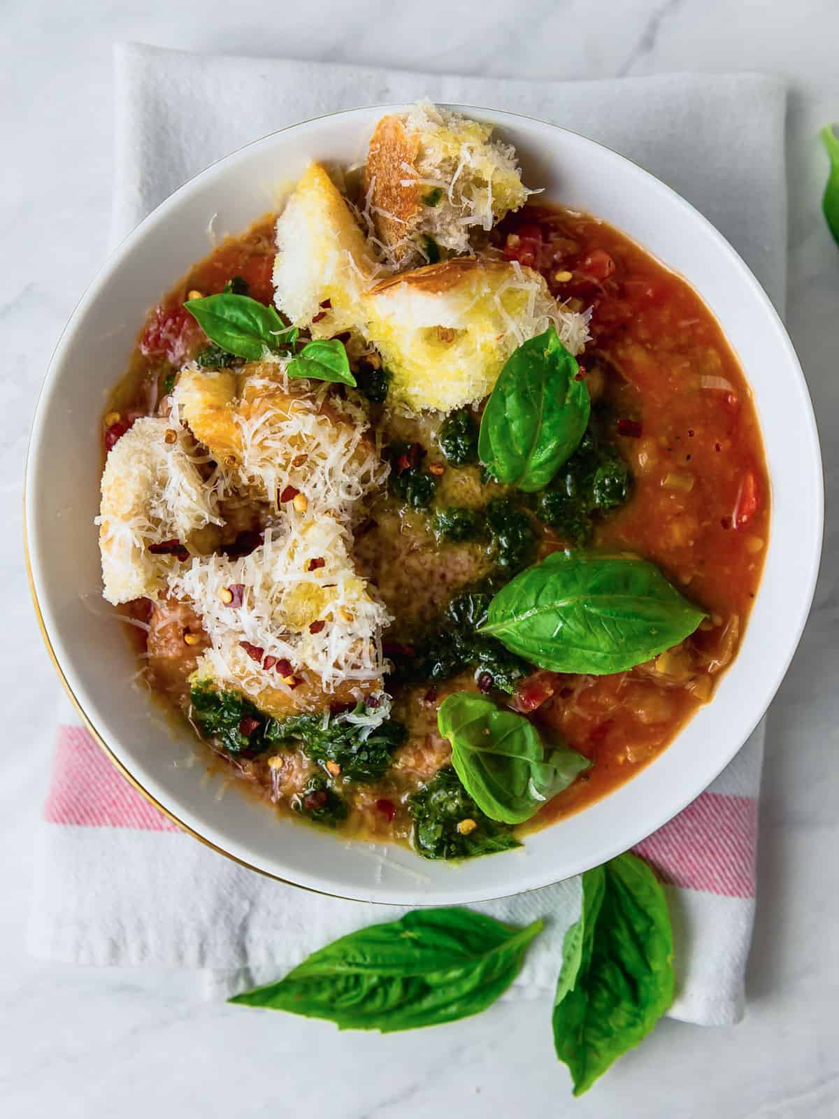 Tuscan ribollita soup is an Italian tomato and bread soup with herbs and beans.