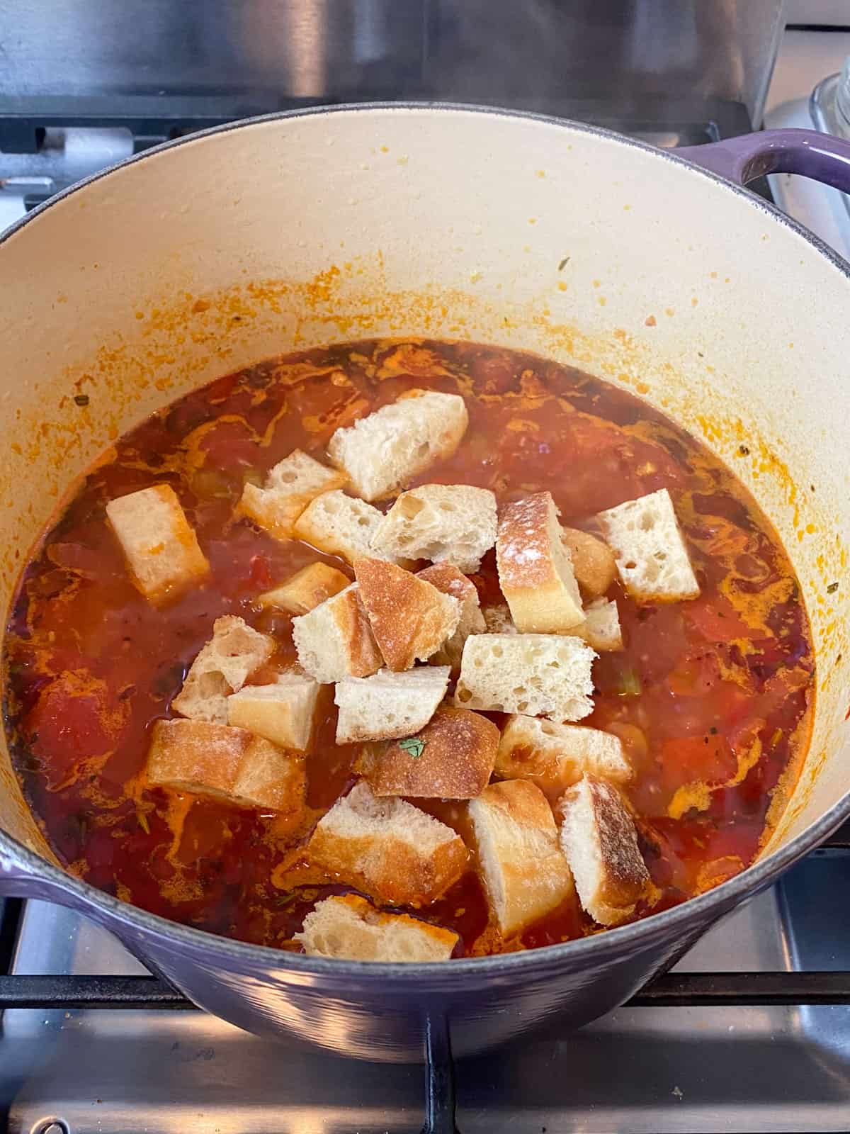 Add cubed bread to the Tuscan bread soup.