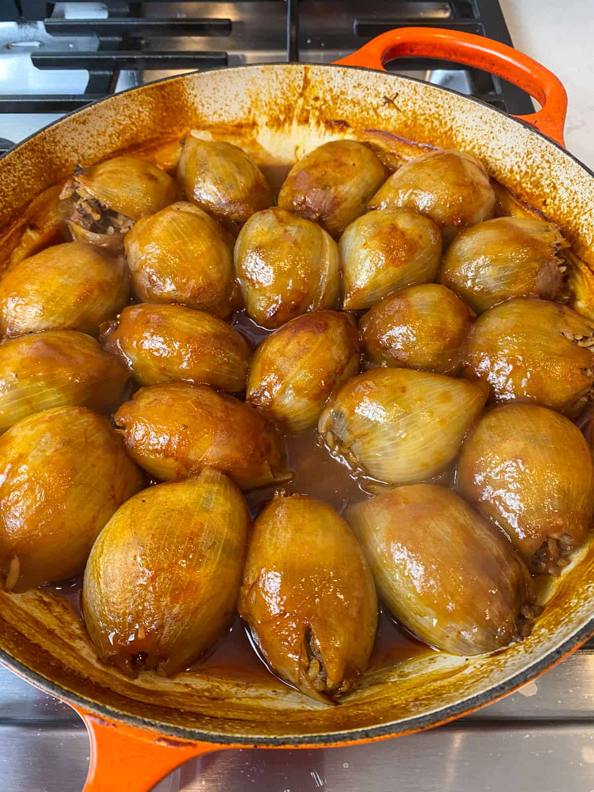 Bake the stuffed onions until tender and the sauce has reduced.