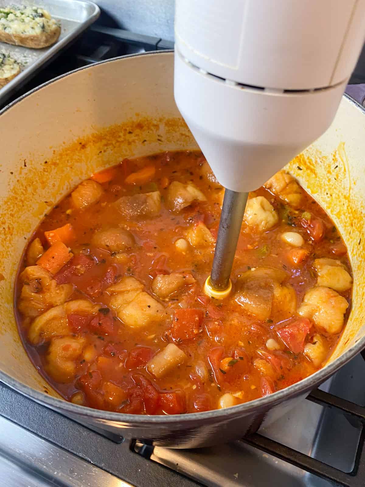 Use an immersion blender to blend some of the bread and tomato soup.