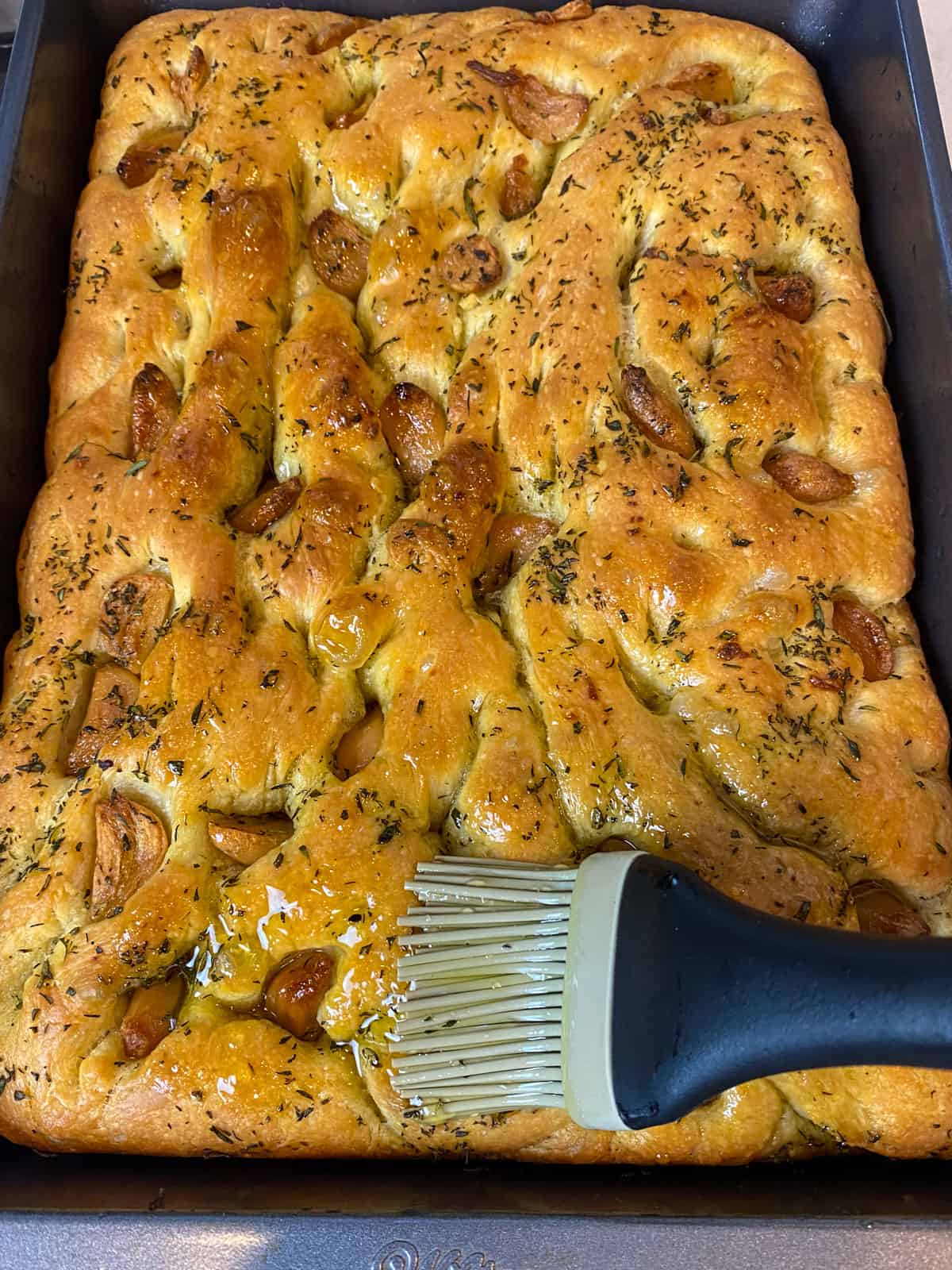 Brush the honey garlic oil onto the baked focaccia bread.