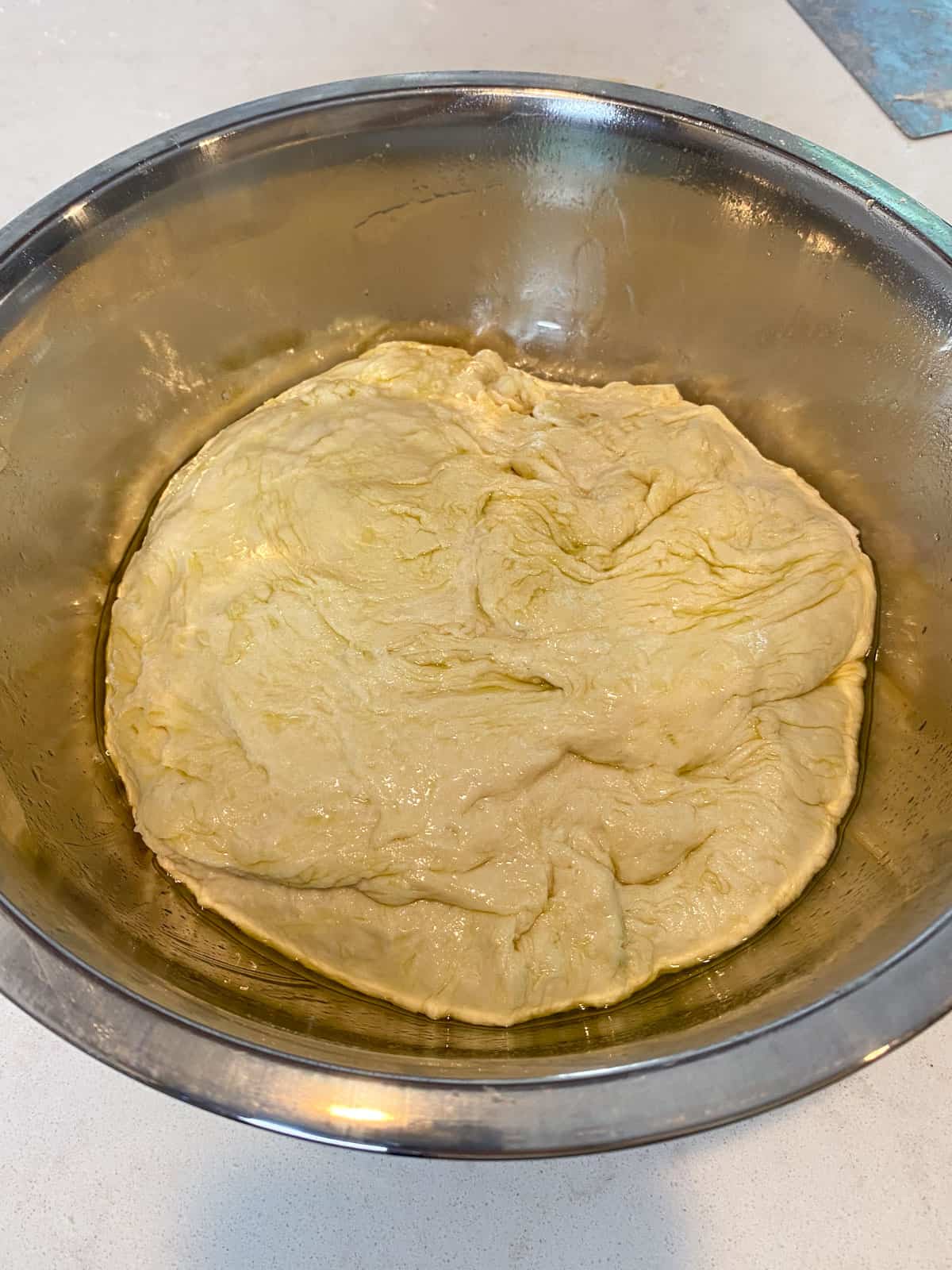 Place the focaccia dough in a lightly oiled bowl.