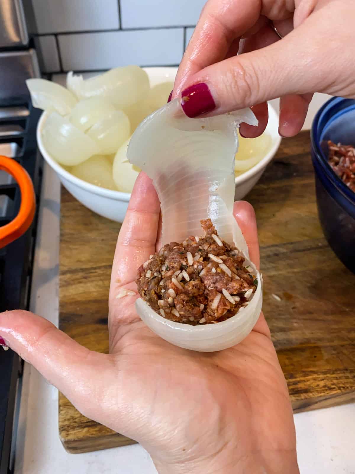 Place a tablespoon sized amount of the meat mixture into the onion layer.