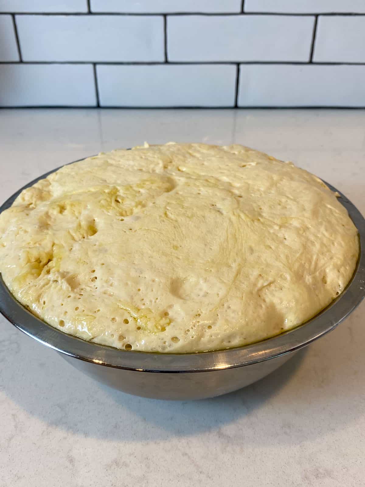 Let the focaccia dough proof until doubled in size.