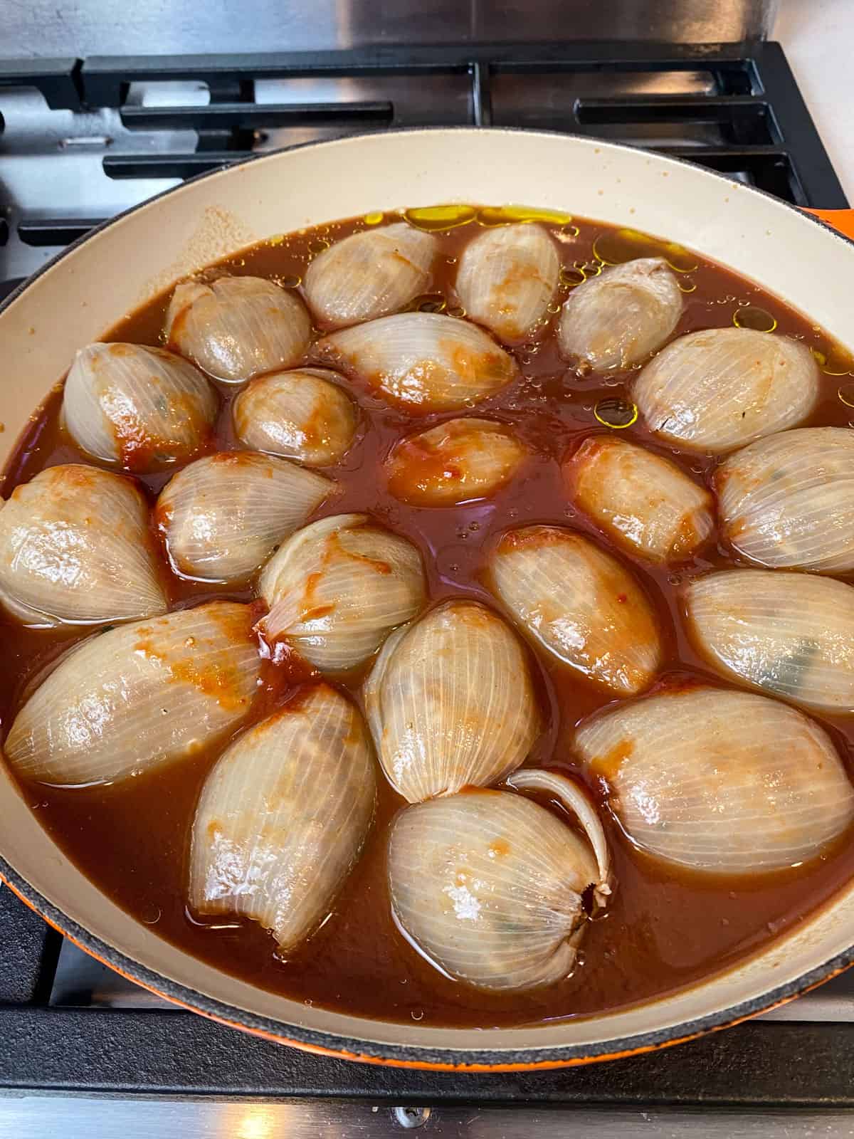 Pour the tomato sauce all over the stuffed onions.